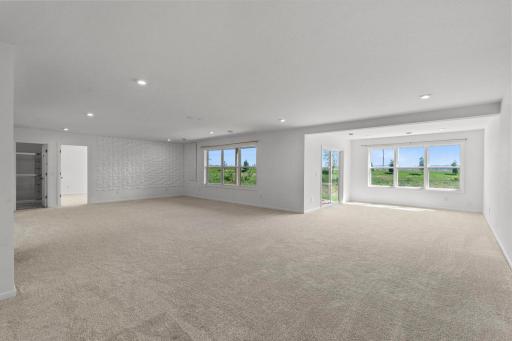 Spacious walkout lower level featuring a 3D accent wall, Alexa-controlled lighting, and a bright, inviting sunroom