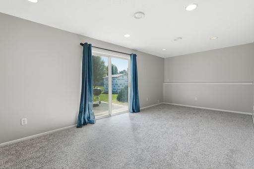 Family room located on the 3rd level walks out to the large concrete patio and backyard