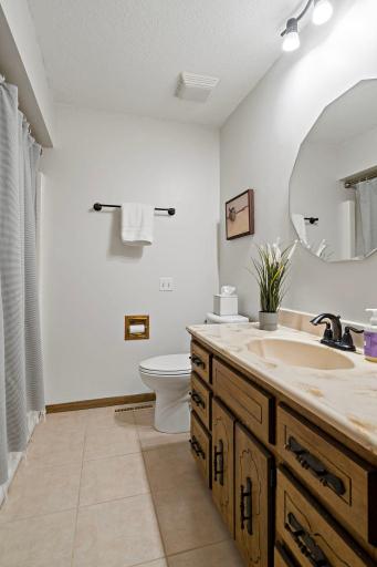 Full bathroom offers plenty of vanity storage and a tub/shower combo, tucked neatly off the main living space