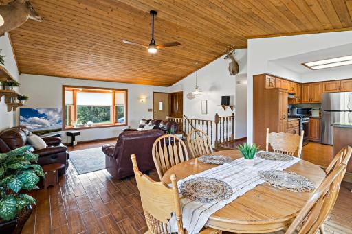 Open-concept living, dining, and kitchen flow seamlessly beneath vaulted wood ceilings â perfect for entertaining or everyday living