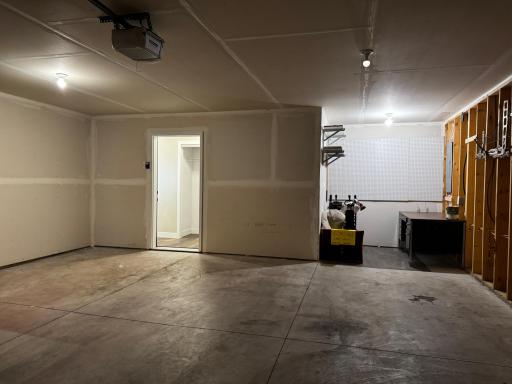 Garage with entry into the home and extra storage area