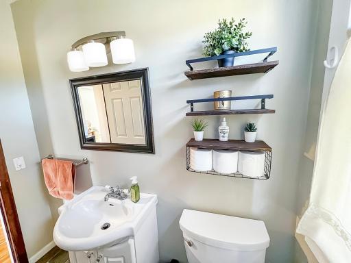 Convenient main-floor bathroom with charming details and a bright, clean feel.