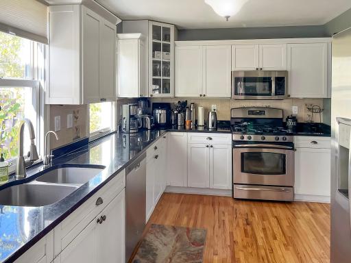 Plenty of room to cook and gather in this well-appointed kitchen with beautiful hardwood floors.