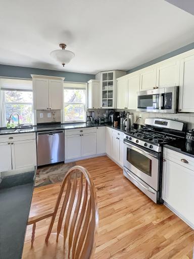 Bright, spacious kitchen featuring granite countertops, stainless steel appliances and an abundance of cabinetry.