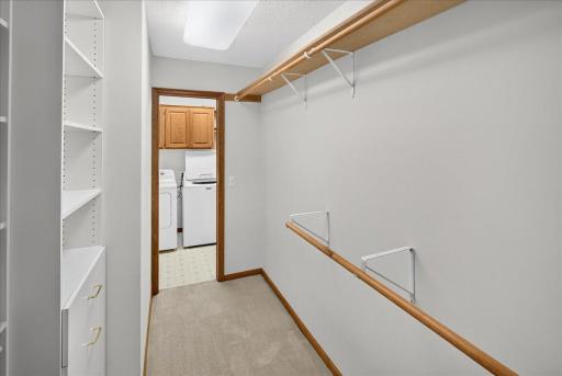 Primary walk-in closet offers direct access to the laundry room for added convenience!