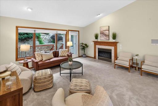 Main level living room with gas fireplace and vaulted ceilings.