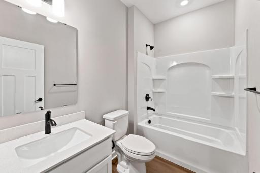 This full-sized bathroom is between the secondary bedrooms and features a single vanity and a shower-tub combination.