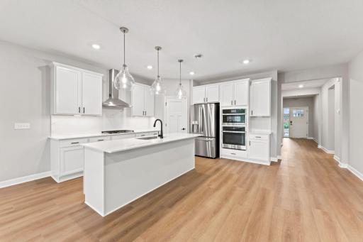 The kitchen features brand-new appliances, ample cabinetry, designer-selected countertops and a pantry for added storage space.