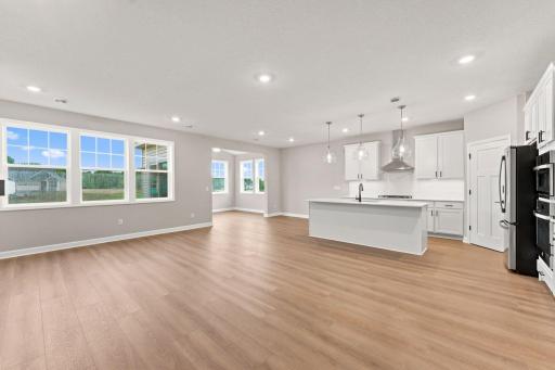 The dining room embraces natural light from a sliding glass door, creating a welcoming space for dinner parties and special occasions.