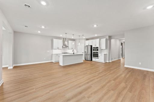 The center island with an undermount stainless steel sink and multicycle dishwasher effortlessly flows to the rest of the home for effortless living