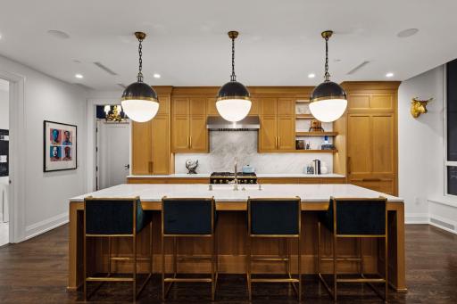 Designer Visual Comfort pendant lighting adds another layer of finish and warmth to the kitchen.