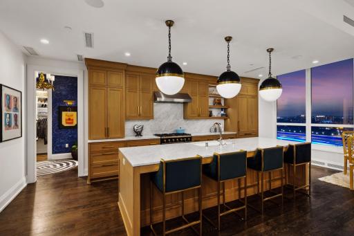 The kitchen was upgraded with a full Carrara marble backsplash, replacing the original limited backsplash with a more substantial and timeless finish.