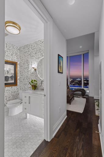 The original lighting plan was redesigned with side sconces, overhead lighting and toe-kick illumination for a more refined layered effect.