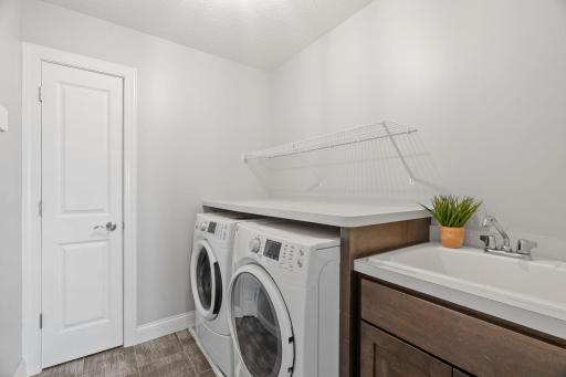 Upper level laundry room with sink