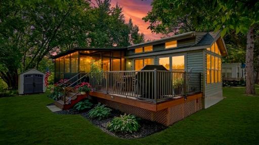 Warm interior lights and glowing transom windows create a welcoming ambience at dusk.