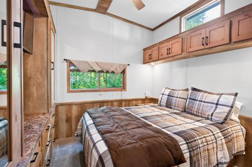 Cozy and efficiently designed, this bedroom combines smart built-in storage solutions with warm aesthetics. Check out the purple luxury mattress.