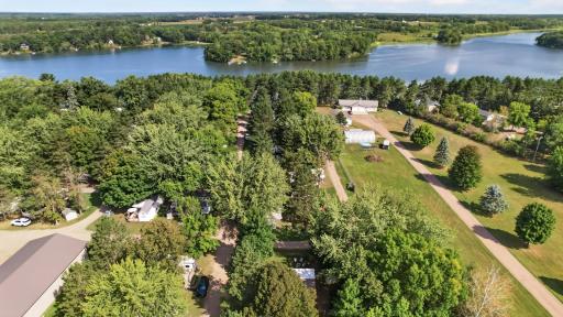 Nestled among Mature trees, with no one behind you offering a quiet and shaded environment. Homw locates in the front of the picture the drone shows the fire pit and chairs.