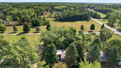 Lush natural surroundings of the community, framed by mature trees, green open spaces, and gentle country roads. No one behind you great for privacy.