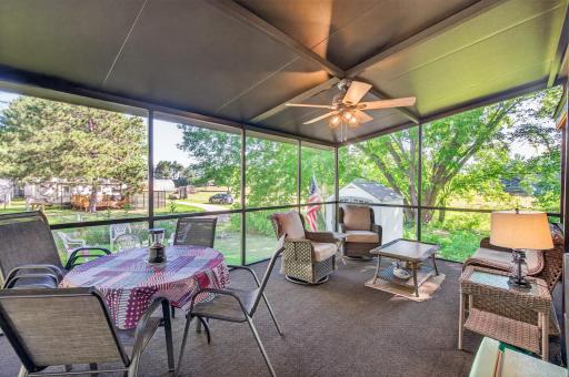 Spacious and inviting, this fully screened-in porch provides a comfortable, bug-free outdoor living area with panoramic views of the lush green surroundings.