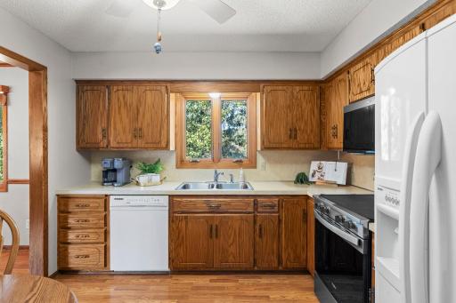 Warm wood cabinetry and abundant natural light create a comfortable kitchen ready for everyday meals and gatherings.