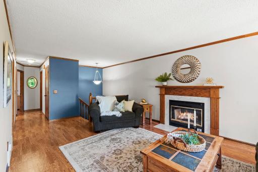 The living room offers a warm and comfortable place to relax, complete with a wood burning fireplace and charming natural wood details.