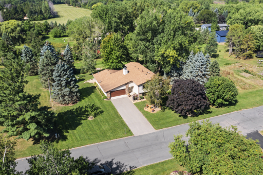 Mature trees and generous green space create a private retreat, with the neighboring lot unable to be built on for added privacy.