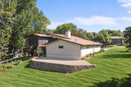 The walkout lower level and three season porch create an easy connection between the home and its beautiful outdoor setting.