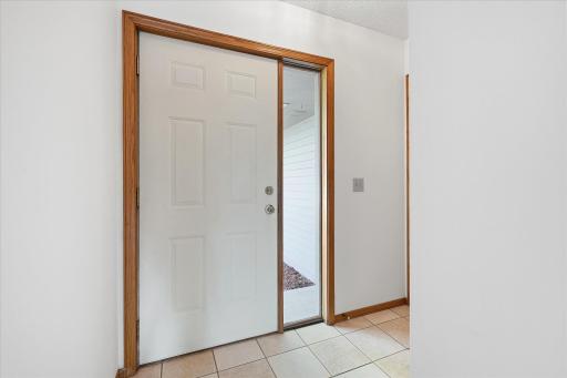 Step inside to a bright, welcoming foyer with ceramic tile floors, a coat closet and direct access to the heated garage.