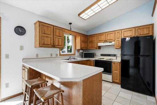 The kitchen offers abundant oak cabinetry and generous counter space, with a functional layout designed for everyday use.