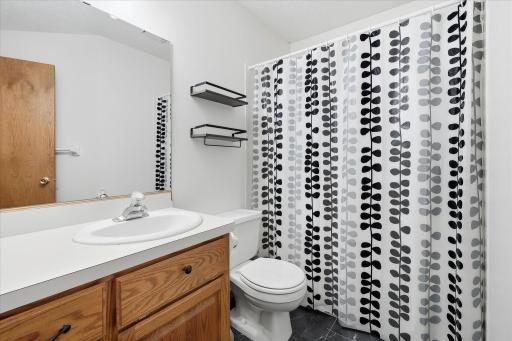 Upper-level full bath features a spacious vanity with plenty of storage and a clean, neutral design.