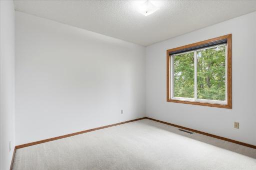 Third upper-level bedroom offers a versatile space ideal for a bedroom, home office, or hobby room.