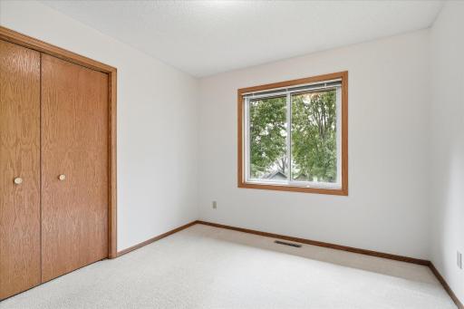 Another view of the second bedroom showcases its comfortable size and closet space.