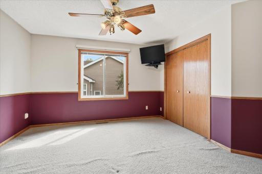 Spacious primary bedroom offers plenty of room for a full bedroom suite along with great natural light and a large double closet.