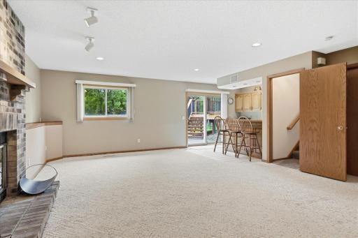 Spacious walkout lower-level family room provides a comfortable second gathering space with plenty of room for relaxing and entertaining.