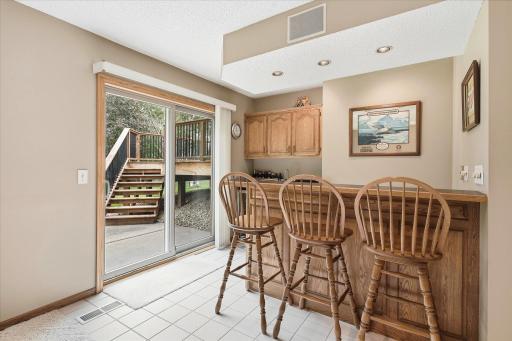 The wet bar adds a great entertaining feature to the lower level with cabinetry, counter space, and seating.
