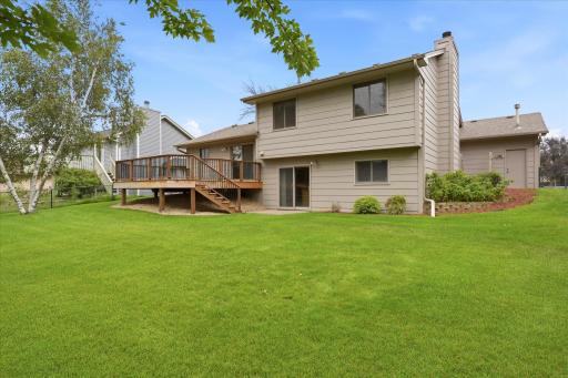 Fully fenced backyard offers plenty of usable lawn space along with multiple areas for relaxing, entertaining, and enjoying the outdoors.
