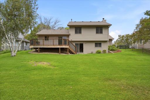 Spacious backyard is enhanced by professional landscaping and an irrigation system to help keep the lawn and landscaping looking their best.