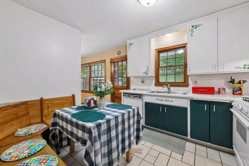 Another view of the eat-in kitchen highlights the backyard-facing window and convenient connection to the dining area and patio.