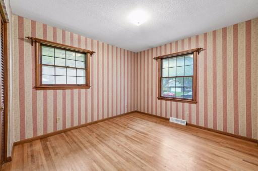 Second bedroom features original red oak hardwood floors, two windows and a generous 10'5" x 10'2" footprint.