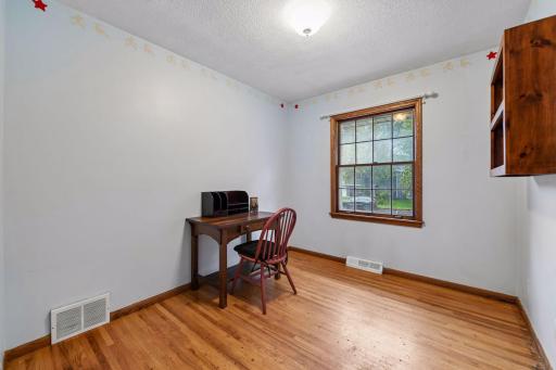 Third bedroom offers original red oak hardwood floors and works well as a bedroom, home office or flex space.