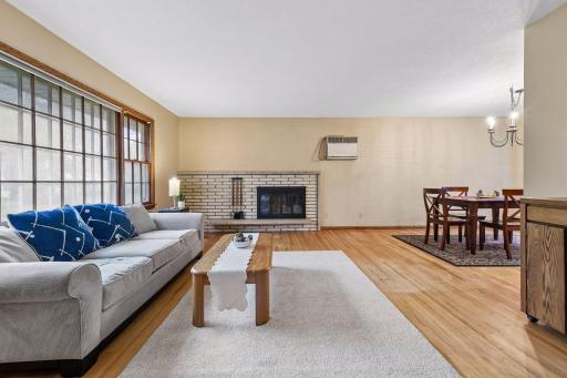 Open living and dining spaces create an easy flow, with original red oak hardwood floors continuing throughout the main living areas.