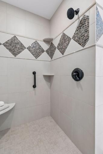 Walk-in custom tiled shower with a built-in seat