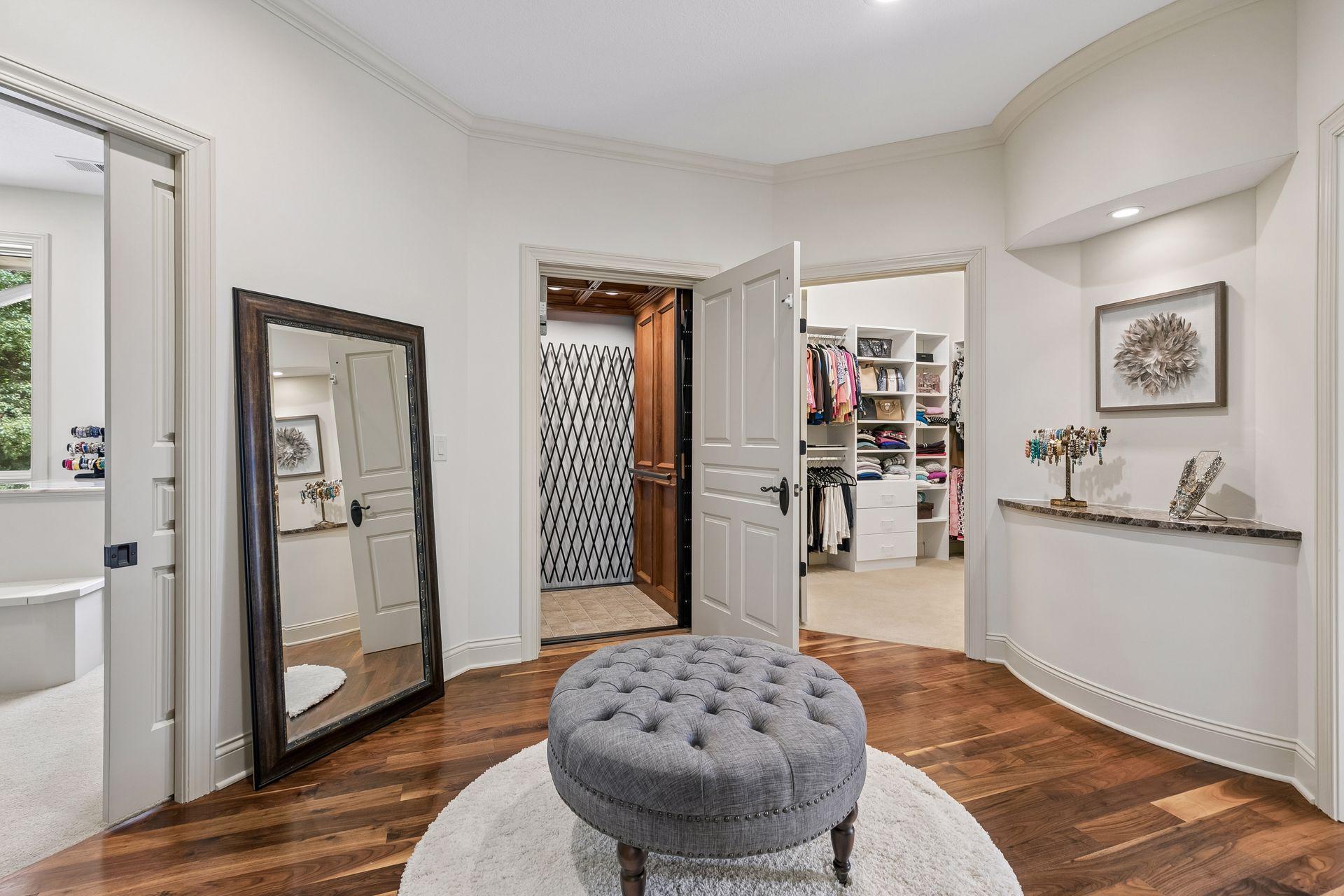 Entry to the elevator from the Primary bedroom, flanked with His and Hers walk-in closets