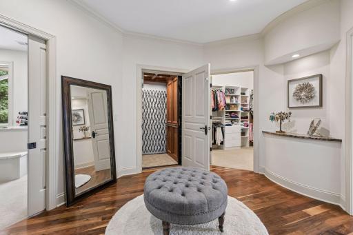 Entry to the elevator from the Primary bedroom, flanked with His and Hers walk-in closets