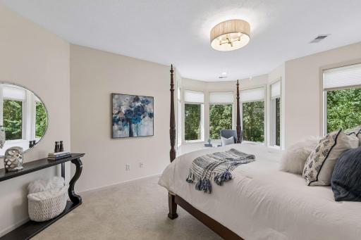 Third bedroom ensuite on the upper level has a large walk-in closet and a reading nook which overlooks the stunning backyard and bluffs