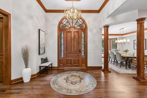 Impressive foyer with 13' ceilings and a beautiful gold light fixture