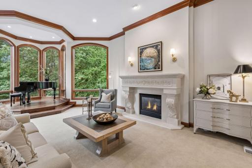 Unique two-sided fireplace highlighted with gold sconces