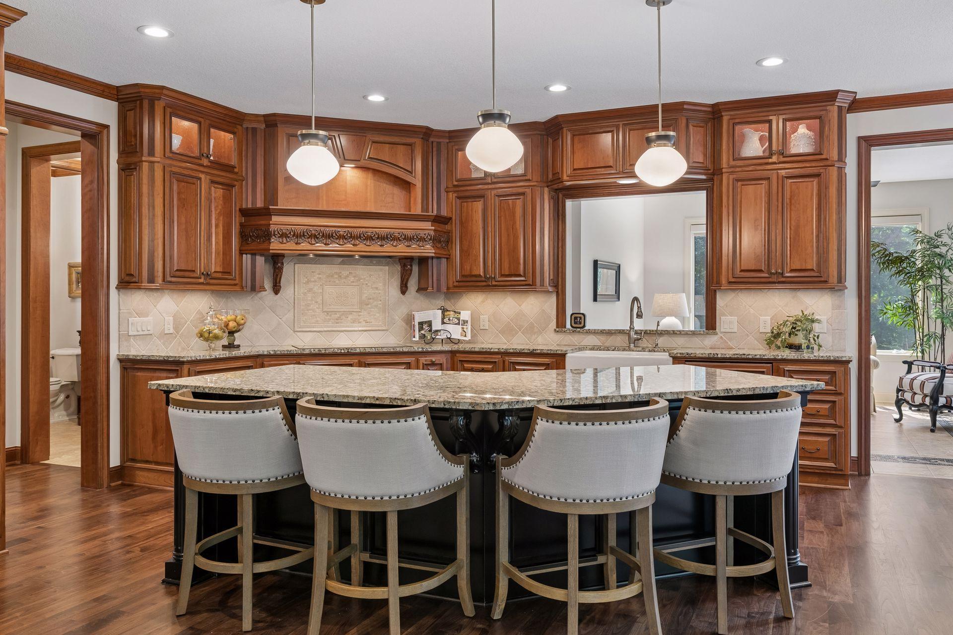 Grand 8' kitchen granite island provides comfortable seating for four and above cabinet lighting