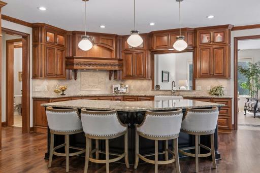 Grand 8' kitchen granite island provides comfortable seating for four and above cabinet lighting
