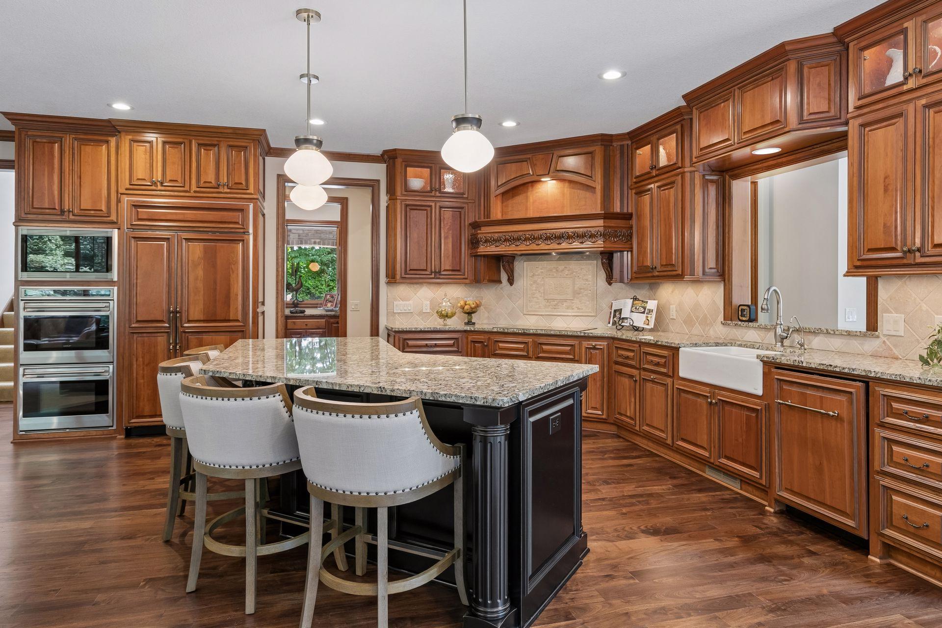 This spacious kitchen is a chef's dream with an abundance of countertop space and plenty of rich American cherry cabinetry with under cabinet lighting
